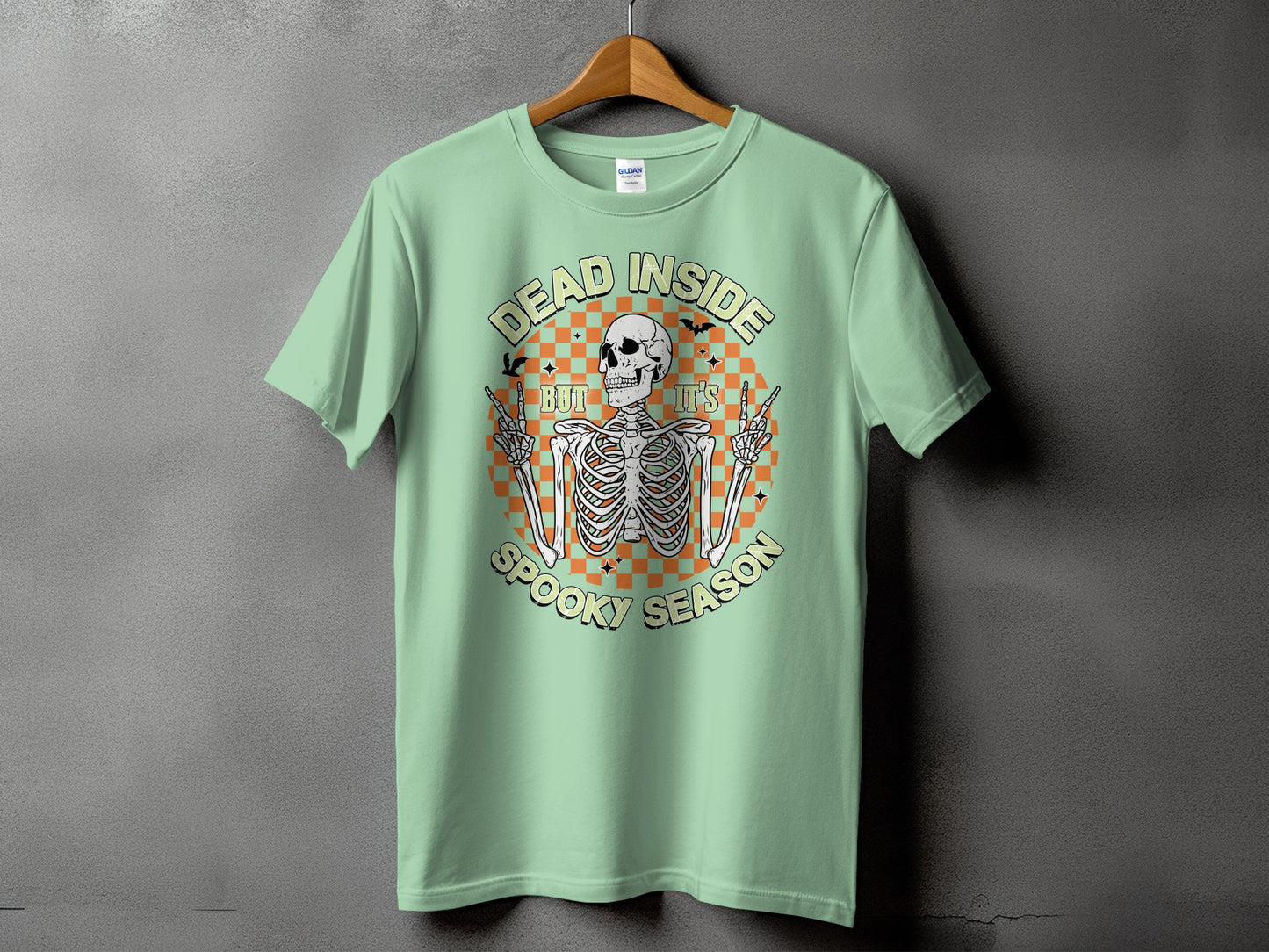 Light green t-shirt with a skeleton graphic that reads "DEAD INSIDE BUT IT'S SPOOKY SEASON".