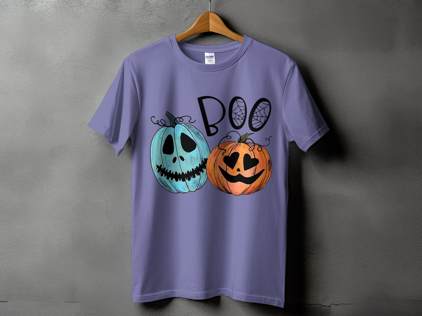 Purple t-shirt with blue and orange cartoon pumpkins and the word "BOO".