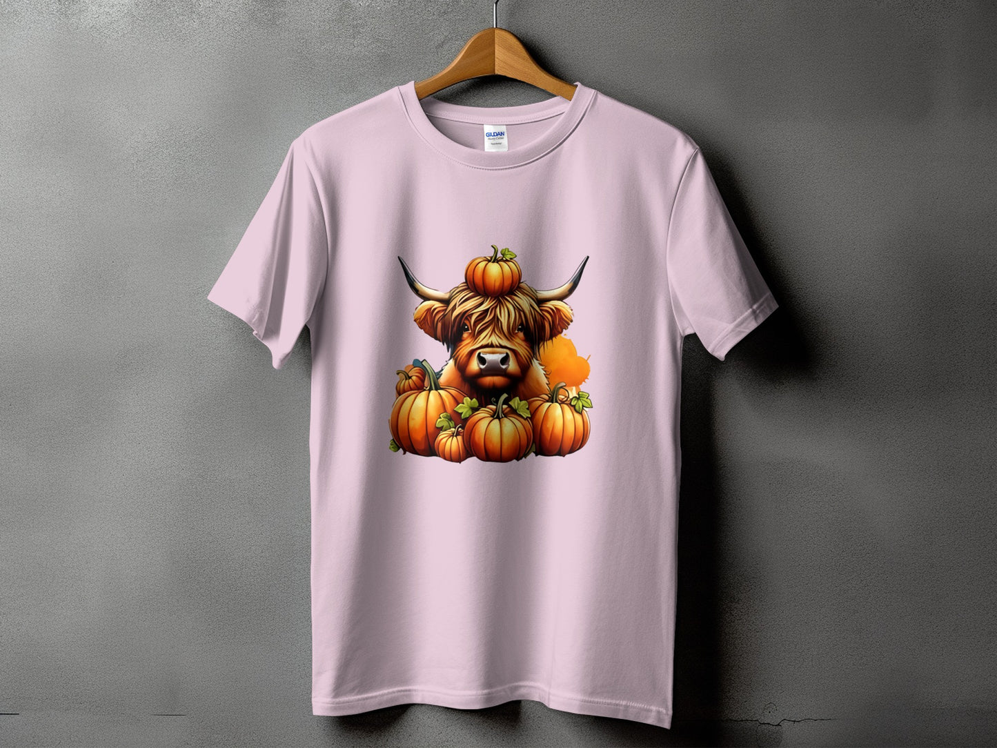 Highland cow with pumpkins on a pink t-shirt.