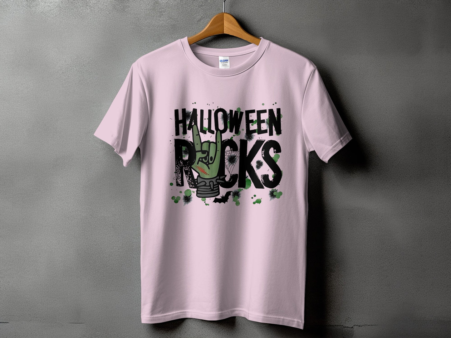 Pink t-shirt with "Halloween Rocks" text and a zombie hand making rock horns.