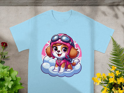 Sky dog wearing pilot goggles on a cloud, on a light blue t-shirt.