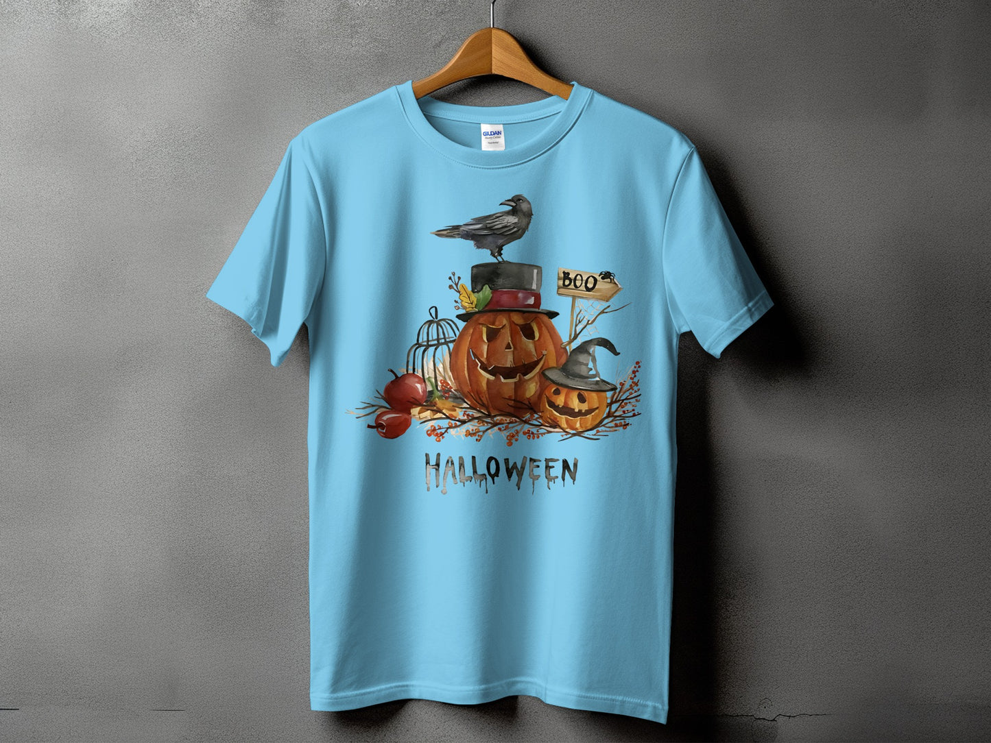 Light blue t-shirt with Halloween graphic featuring pumpkins, a crow, and the word "Halloween."