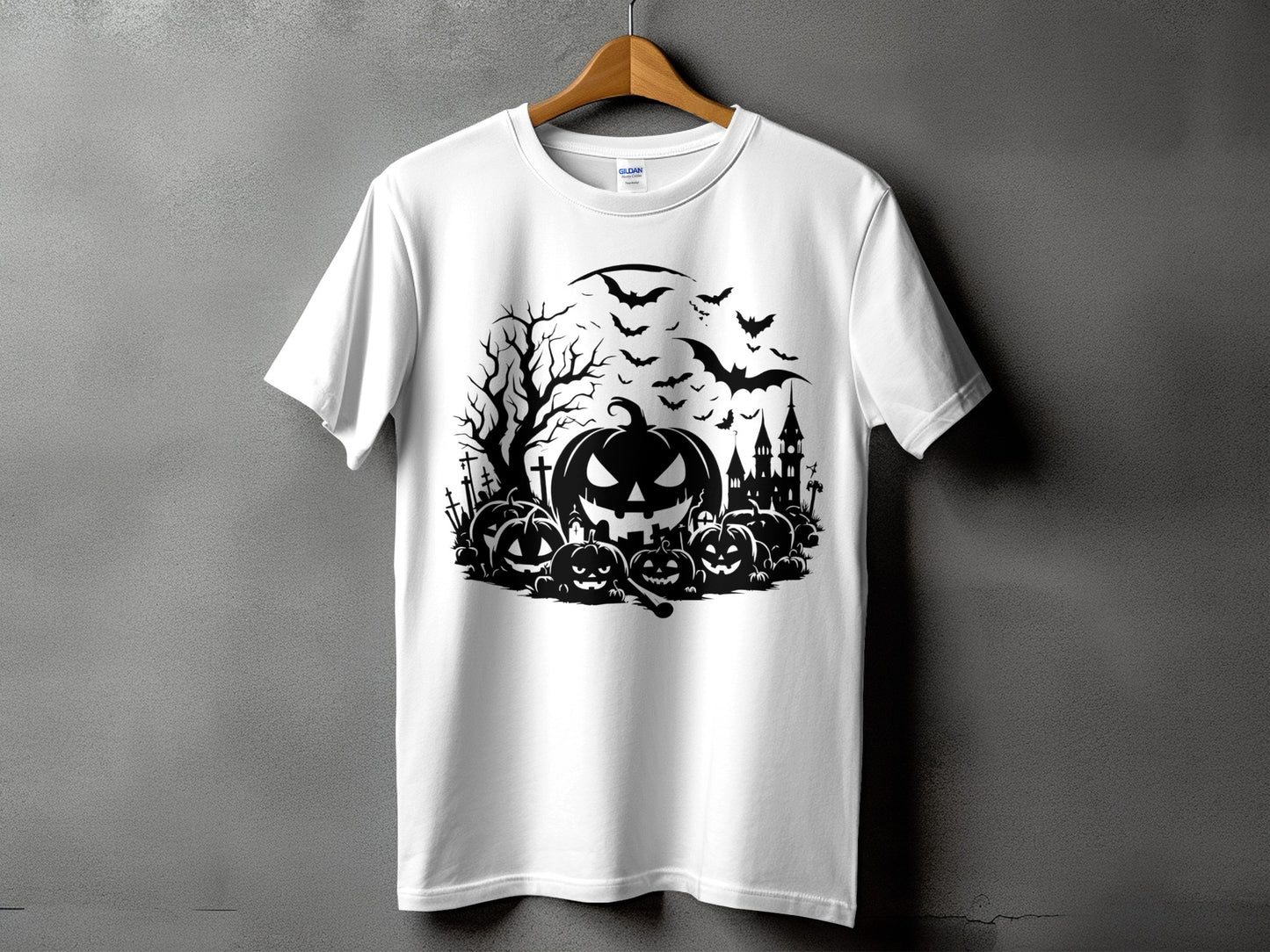 White t-shirt with a black Halloween graphic featuring pumpkins, bats, and a haunted castle.