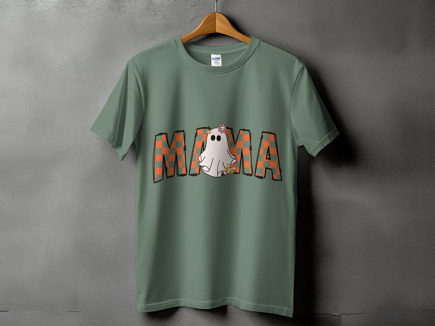 Green t-shirt with "MAMA" in orange plaid and a ghost graphic.