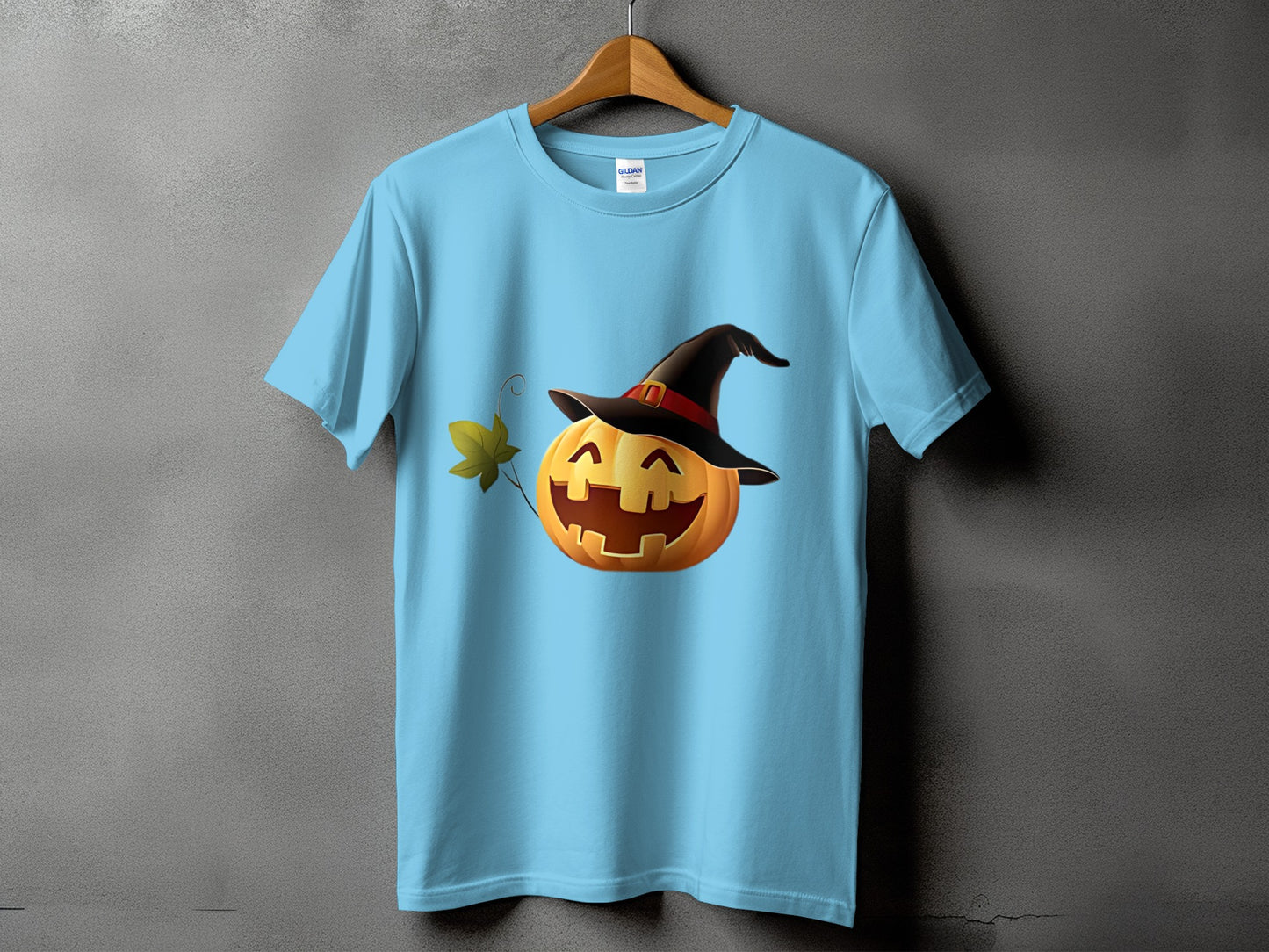 Light blue t-shirt with a cartoon jack-o'-lantern wearing a witch hat.