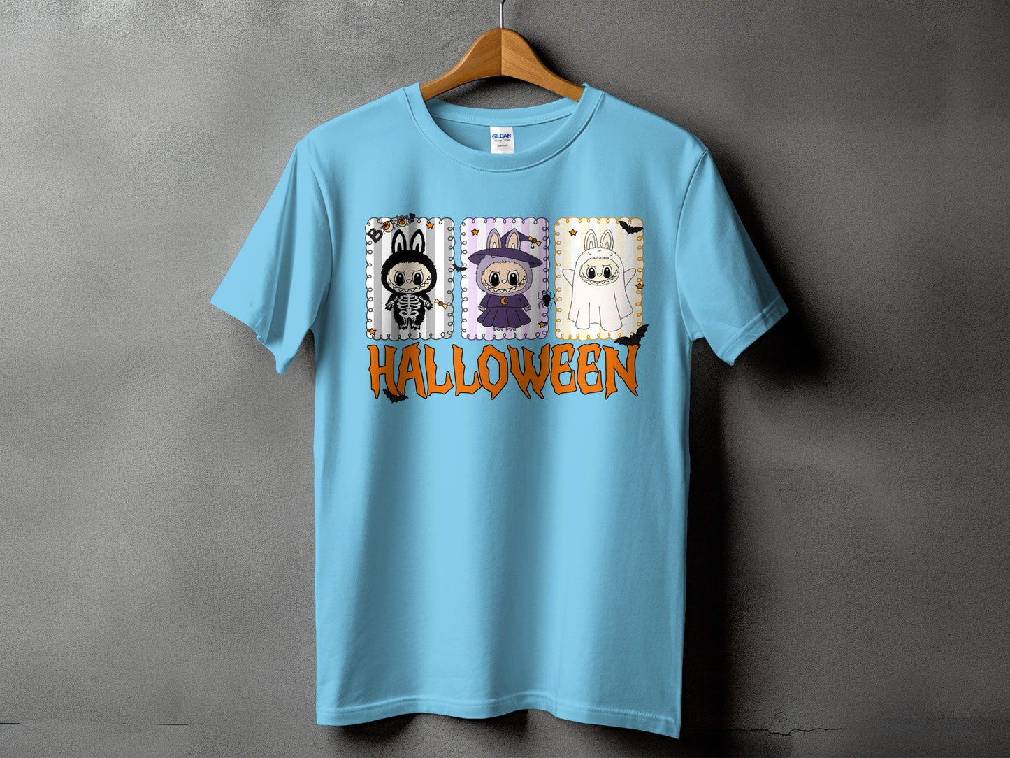 Light blue t-shirt with cartoon bunnies in Halloween costumes and the word "HALLOWEEN".