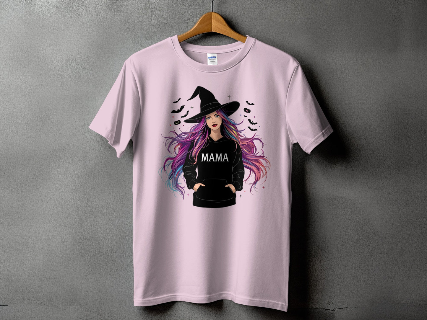 Pink t-shirt with Halloween graphic of a witch with colorful hair and the word "MAMA".
