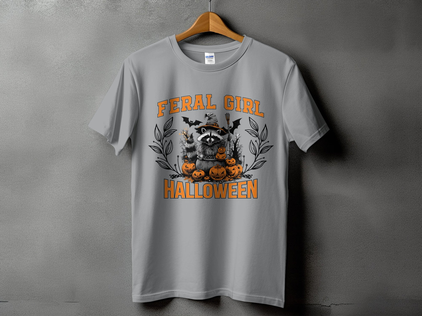 Grey t-shirt with Halloween raccoon and pumpkins graphic, "FERAL GIRL HALLOWEEN" text.