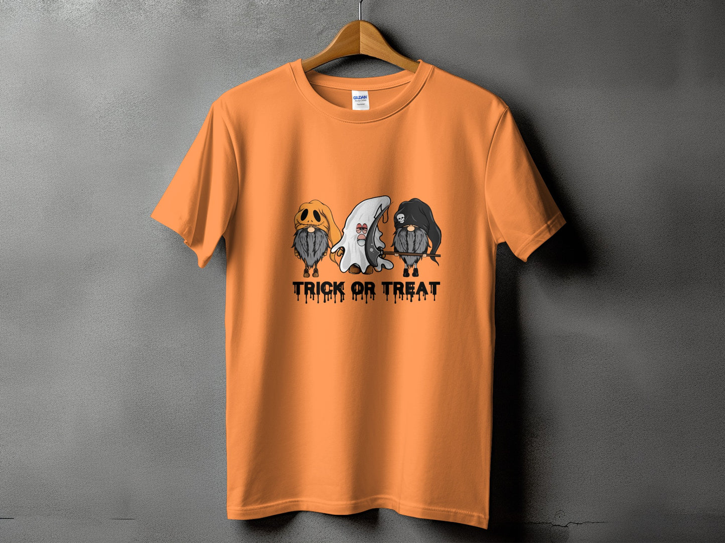 Orange t-shirt with three Halloween gnomes and dripping text "TRICK OR TREAT".