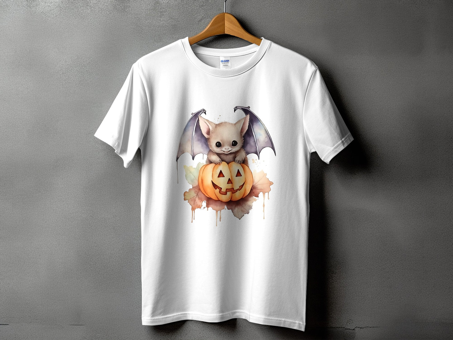 White t-shirt featuring a cute bat sitting on a jack-o'-lantern.