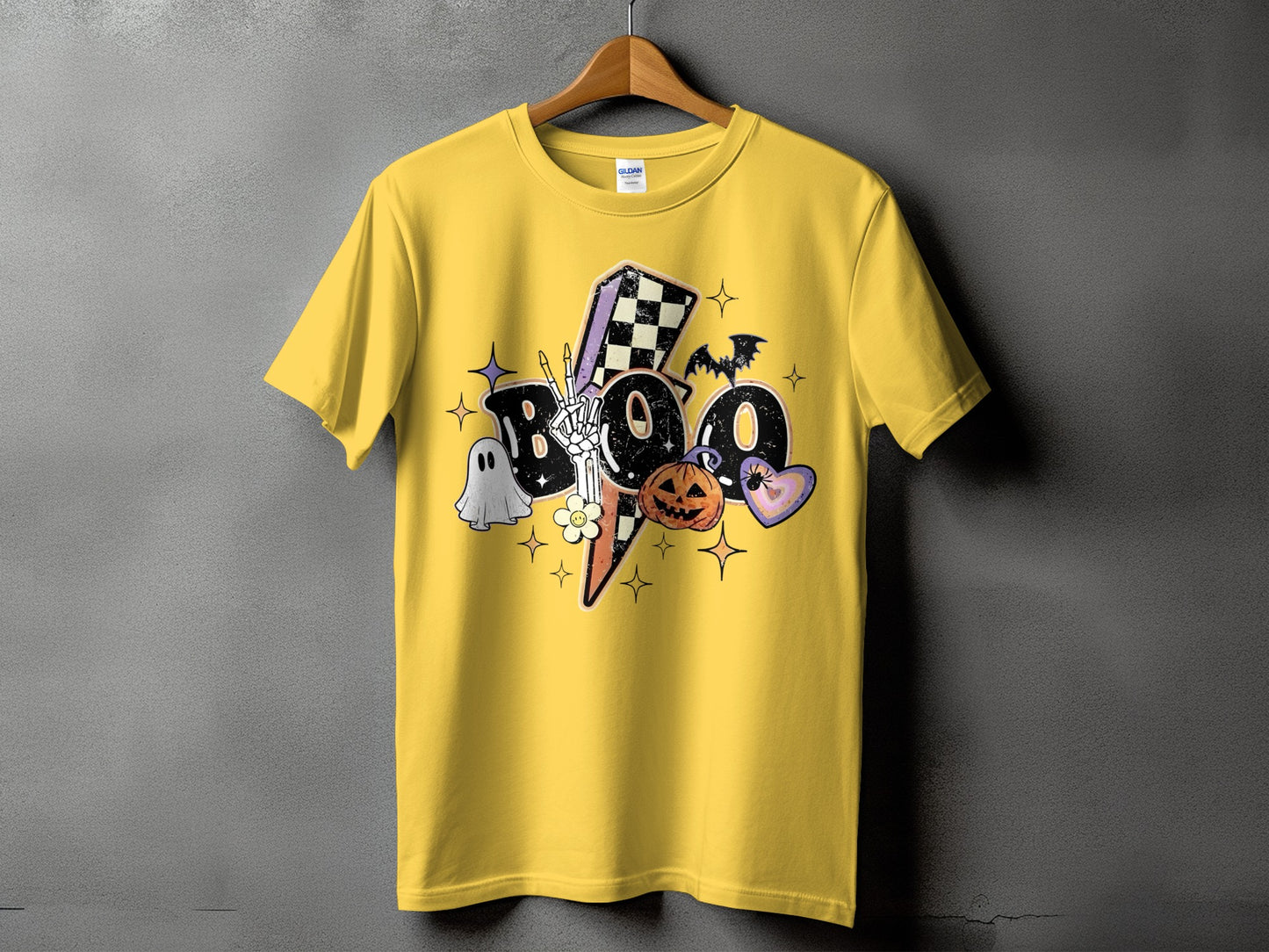 Yellow t-shirt with a graphic featuring "Boo" text, ghost, pumpkin, and bat.