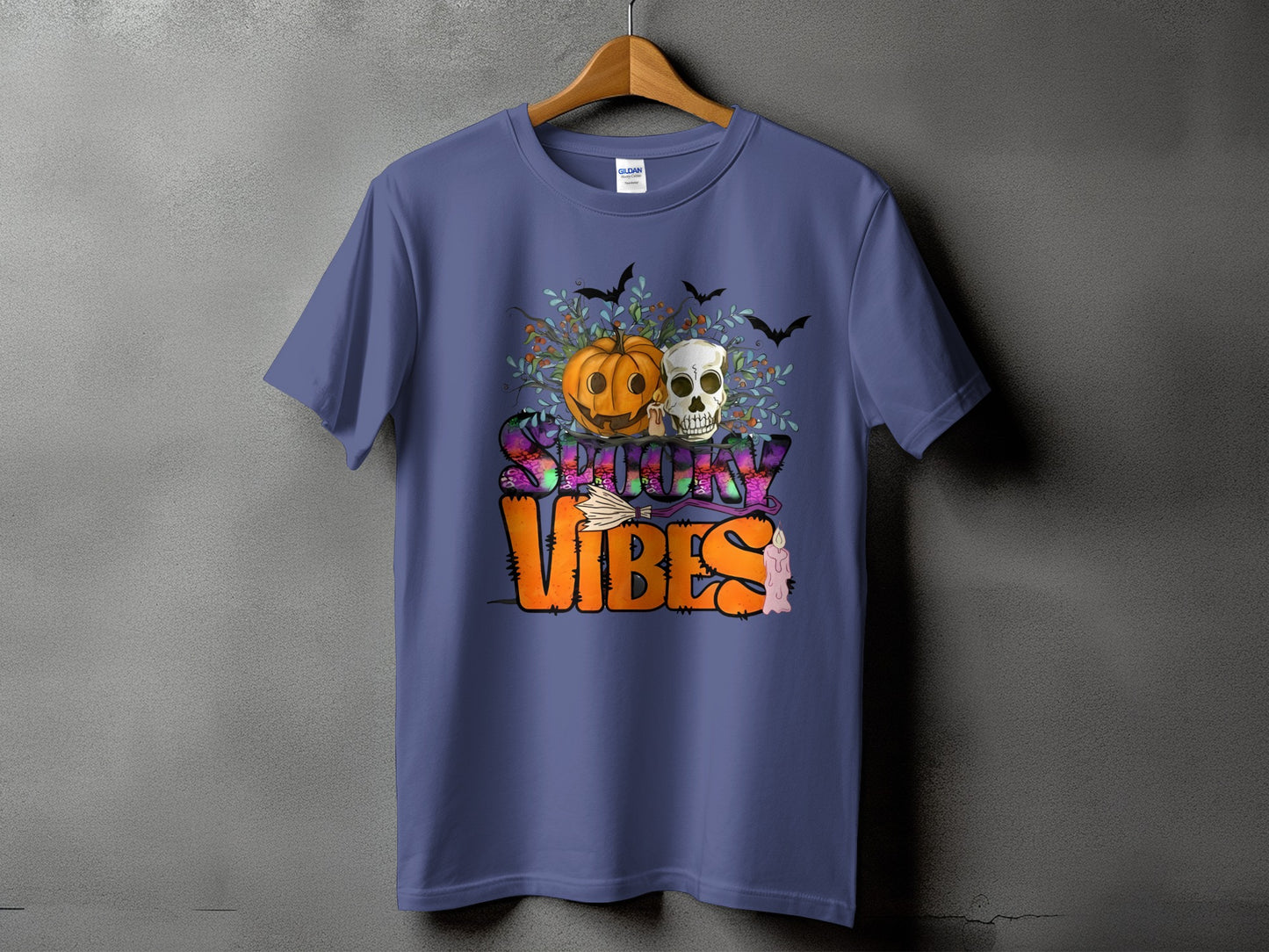 Purple t-shirt with "Spooky Vibes" text featuring a pumpkin, skull, bats, and candle.