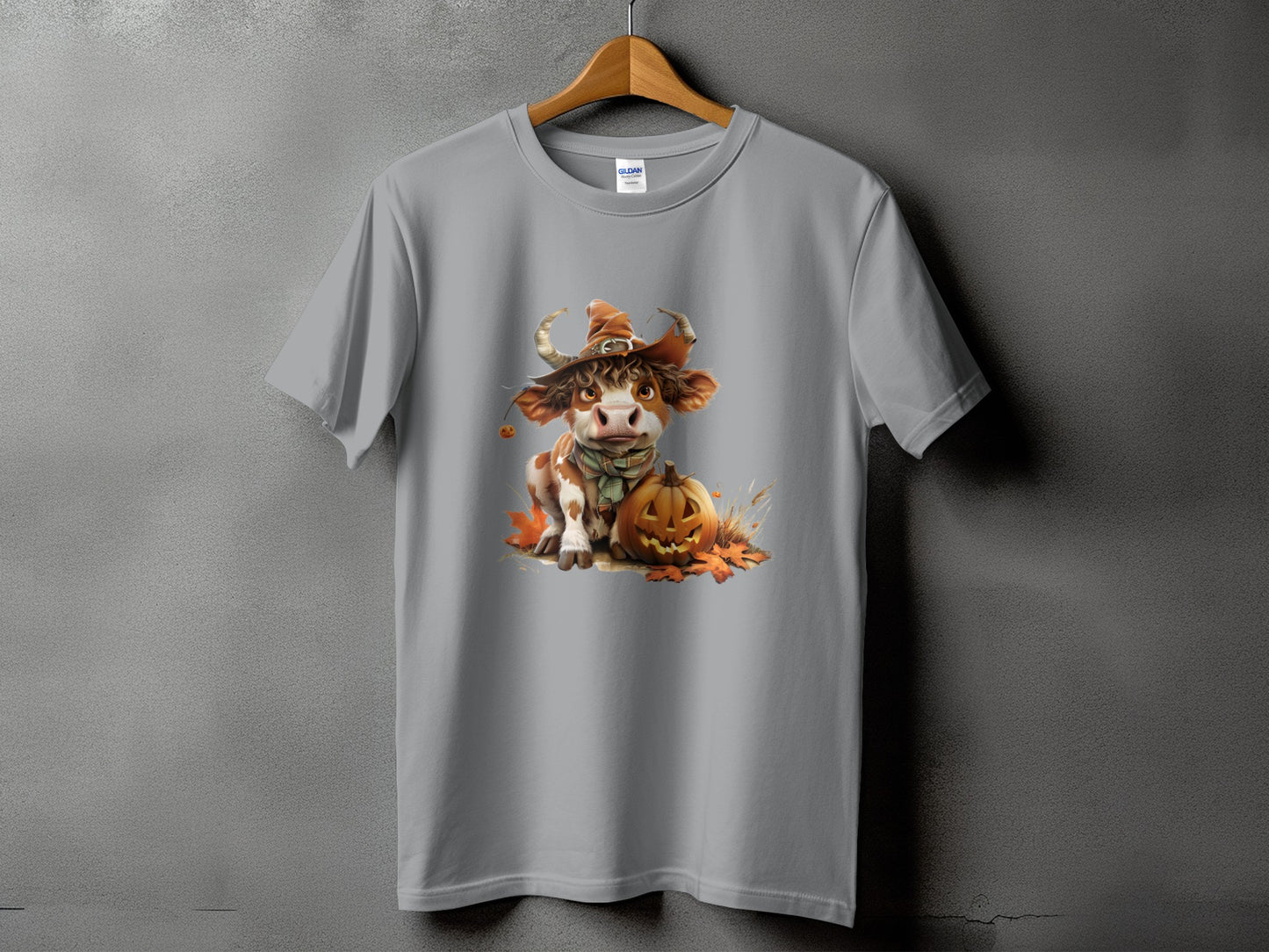 Gray t-shirt featuring a cute cow wearing a witch hat with a pumpkin.