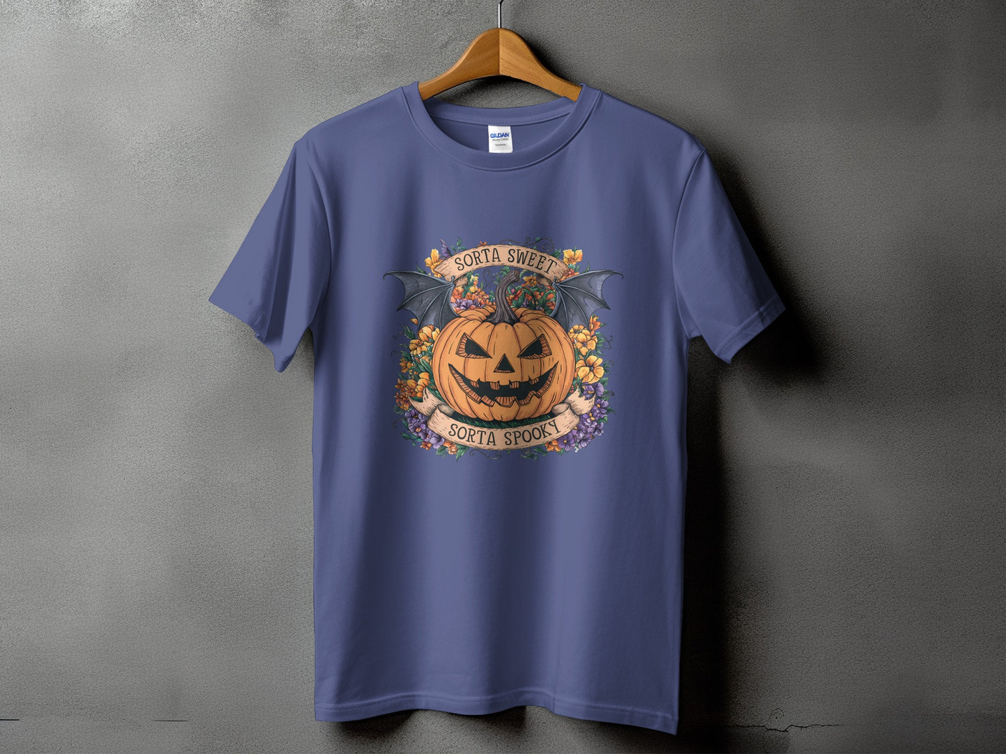 Purple t-shirt with a Halloween graphic featuring a jack-o'-lantern, bat wings, and text.