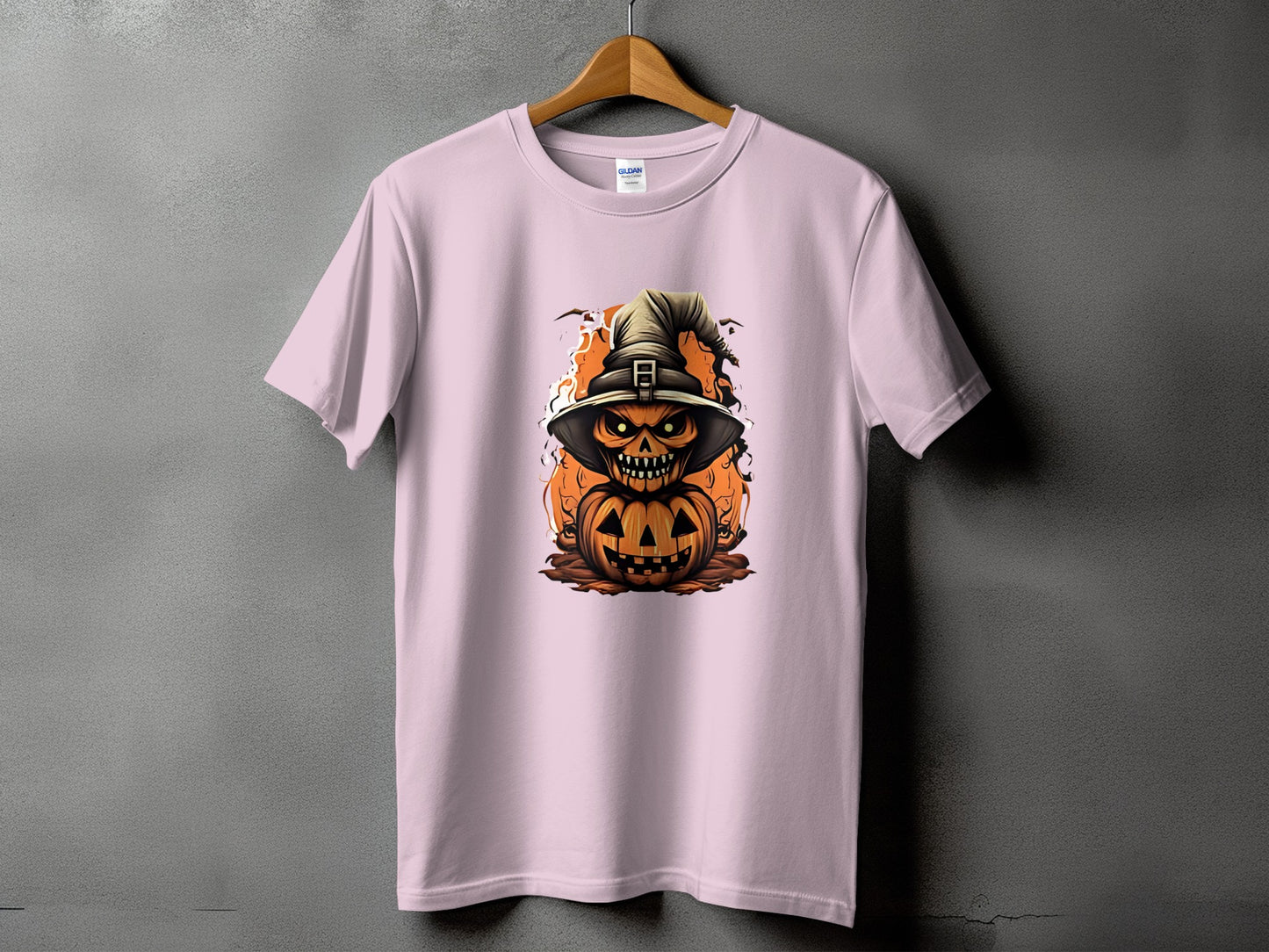 Pink t-shirt with stacked jack-o'-lantern illustration wearing a witch hat.