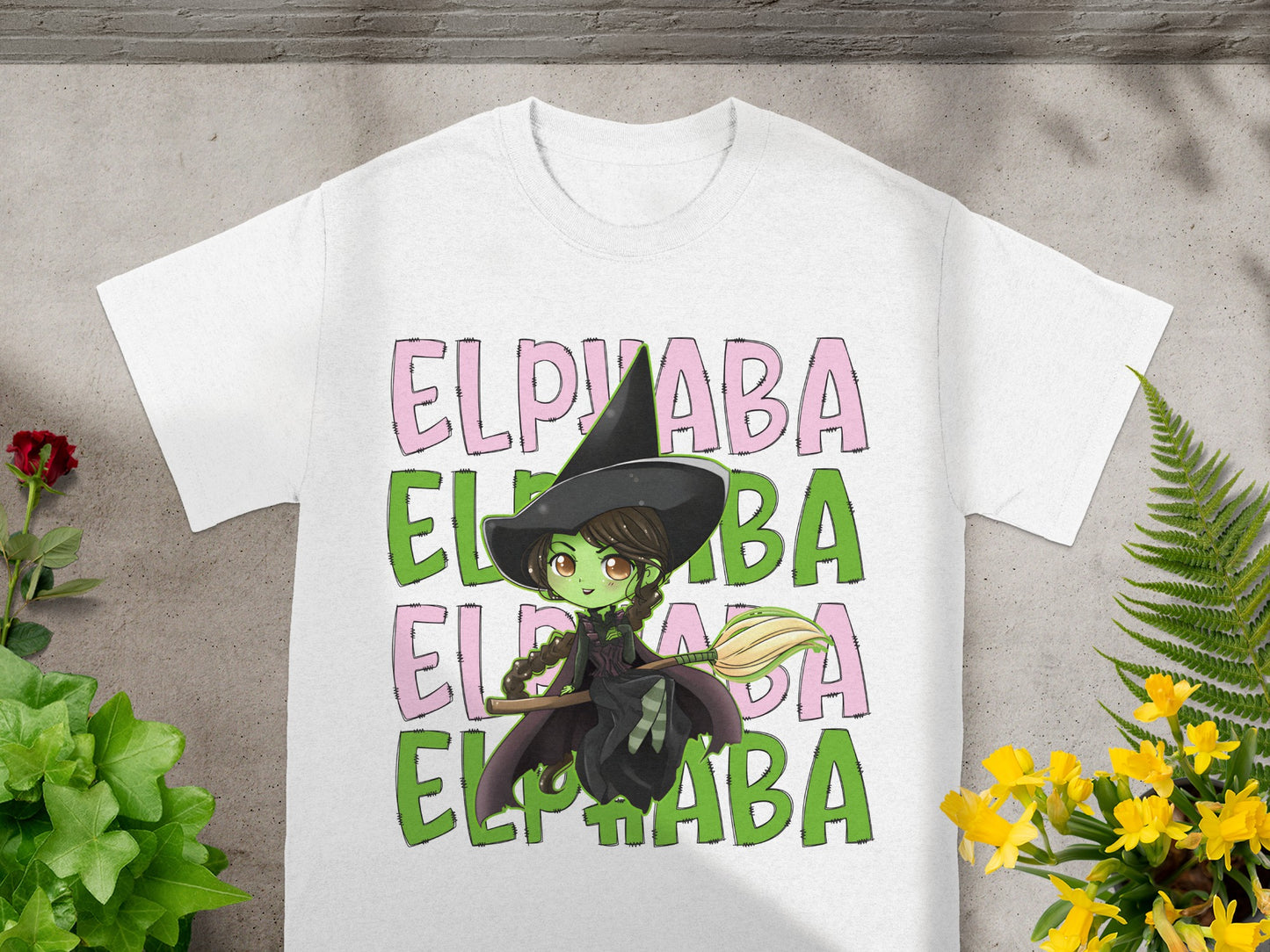 White t-shirt with Elphaba text and witch illustration.