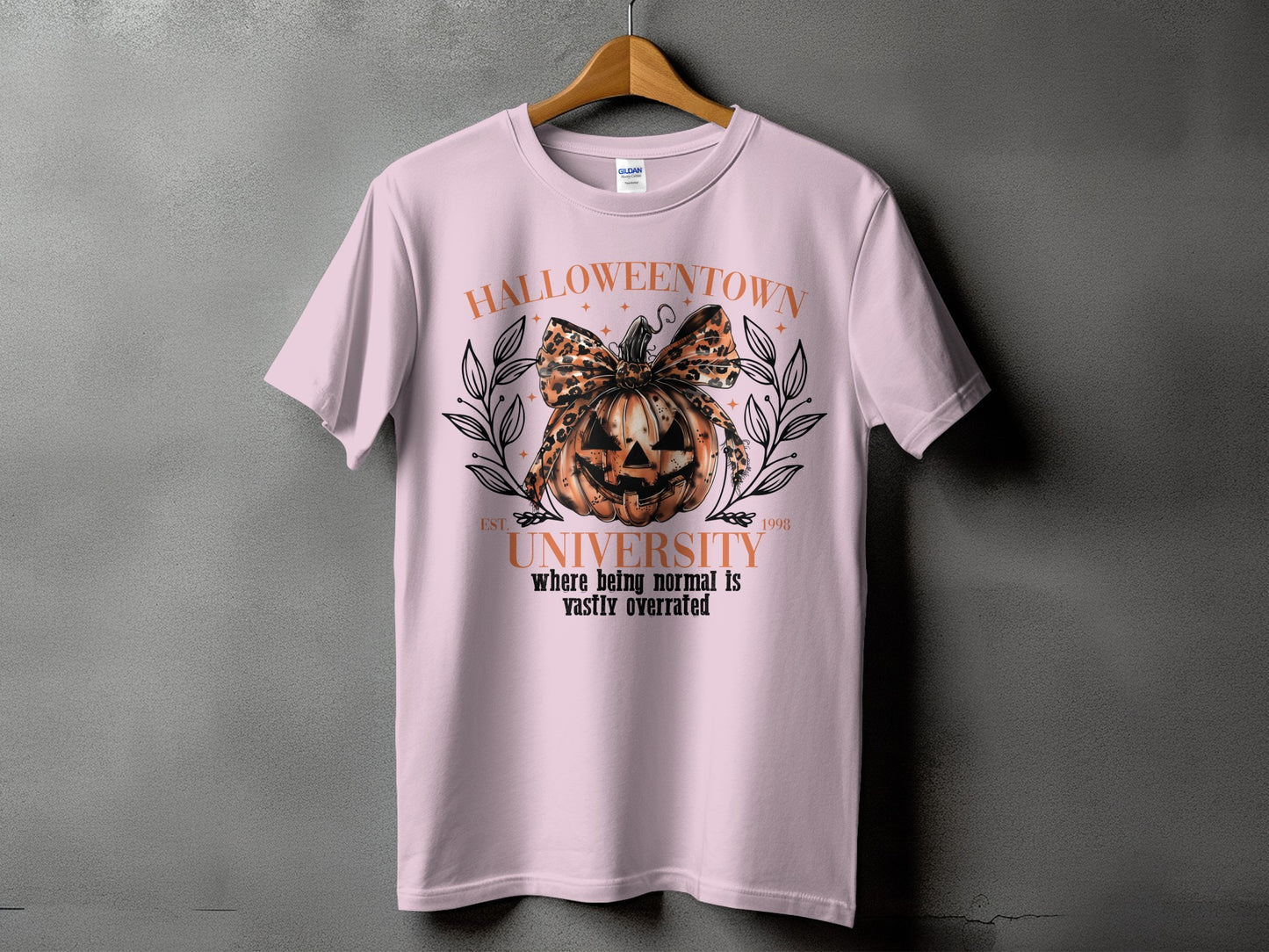 Light pink t-shirt with "Halloweentown University" graphic featuring a jack-o'-lantern and leopard print bow.