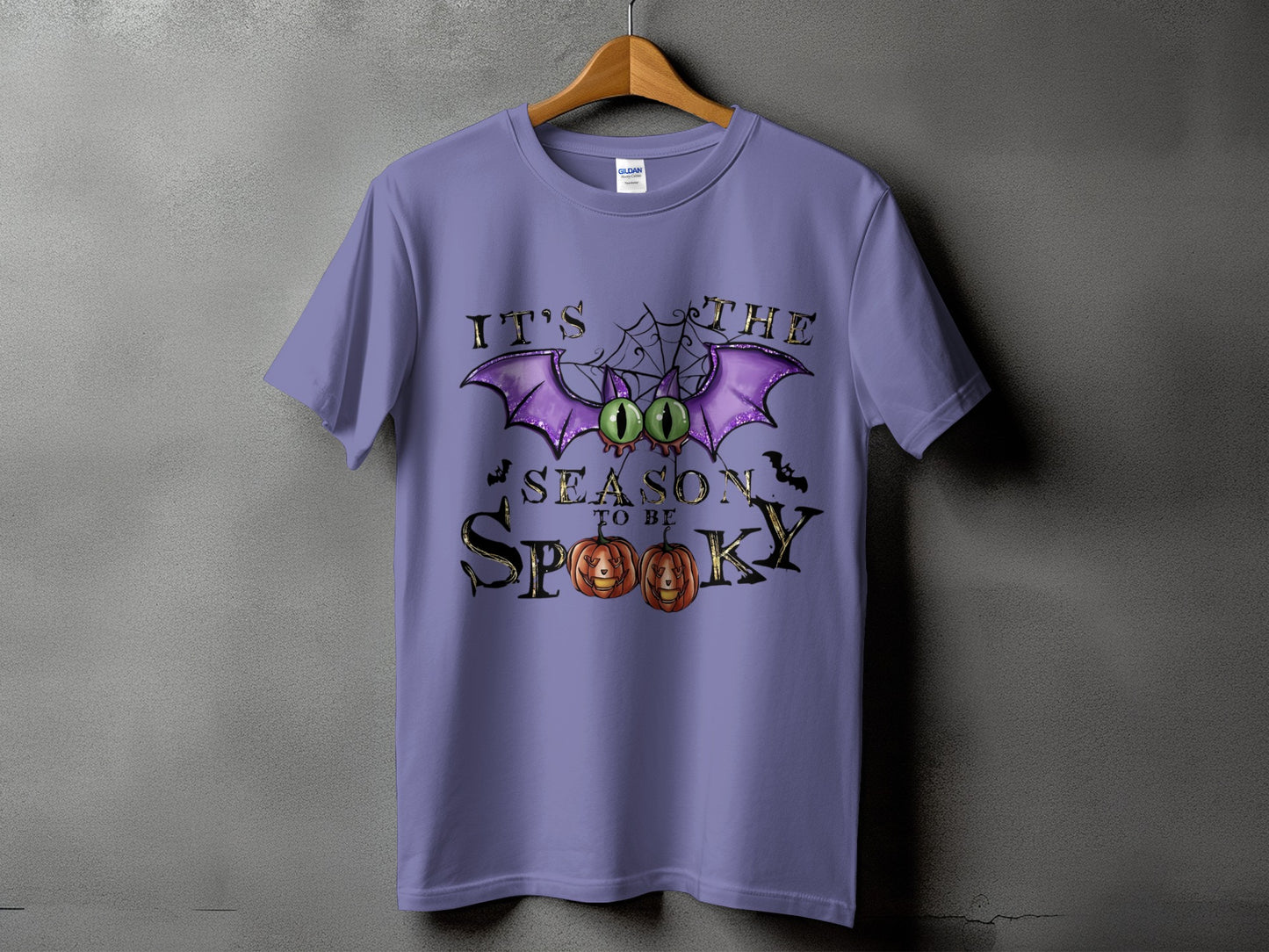Purple t-shirt with "It's the season to be spooky" Halloween graphic.