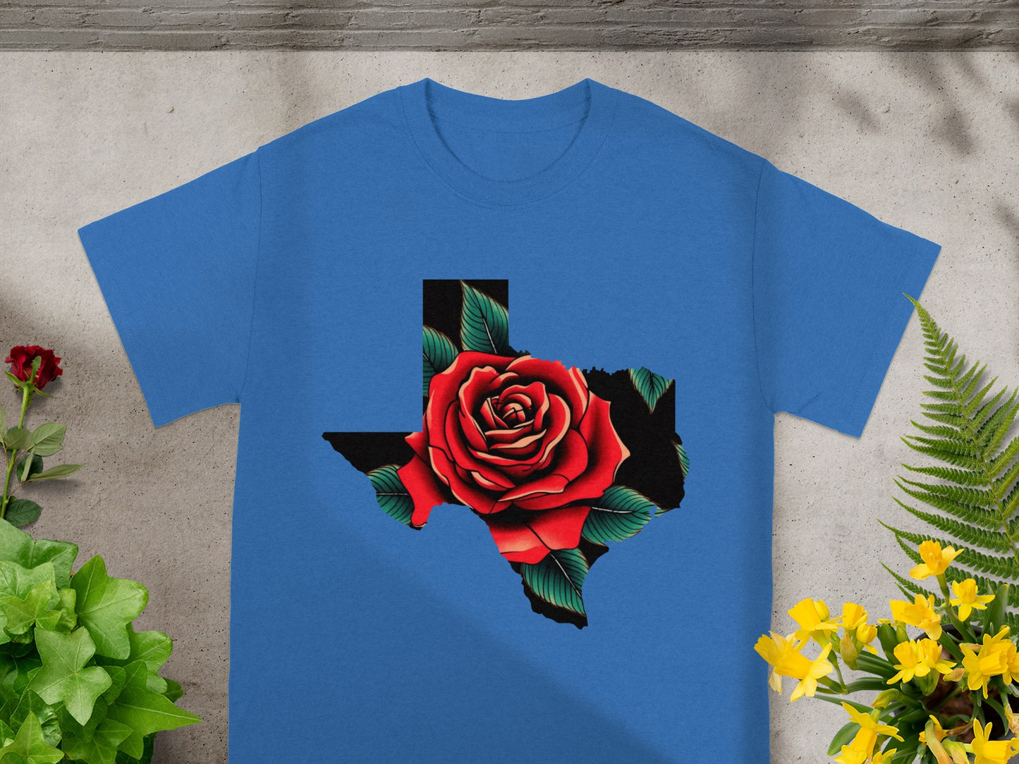 Blue t-shirt with a Texas outline filled with a red rose and green leaves design.