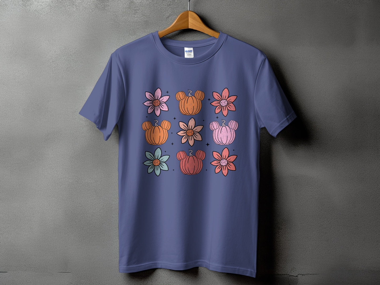 Purple t-shirt with a nine-panel floral and pumpkin design.