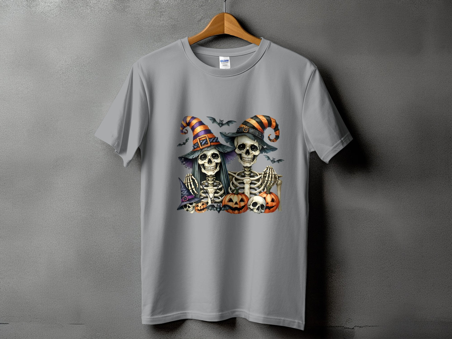 Two skeletons wearing witch hats with bats and pumpkins.