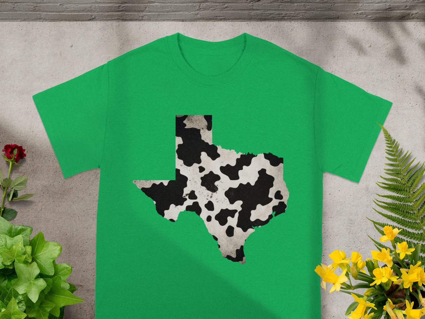 Green t-shirt with a cow-print Texas outline graphic on the front.