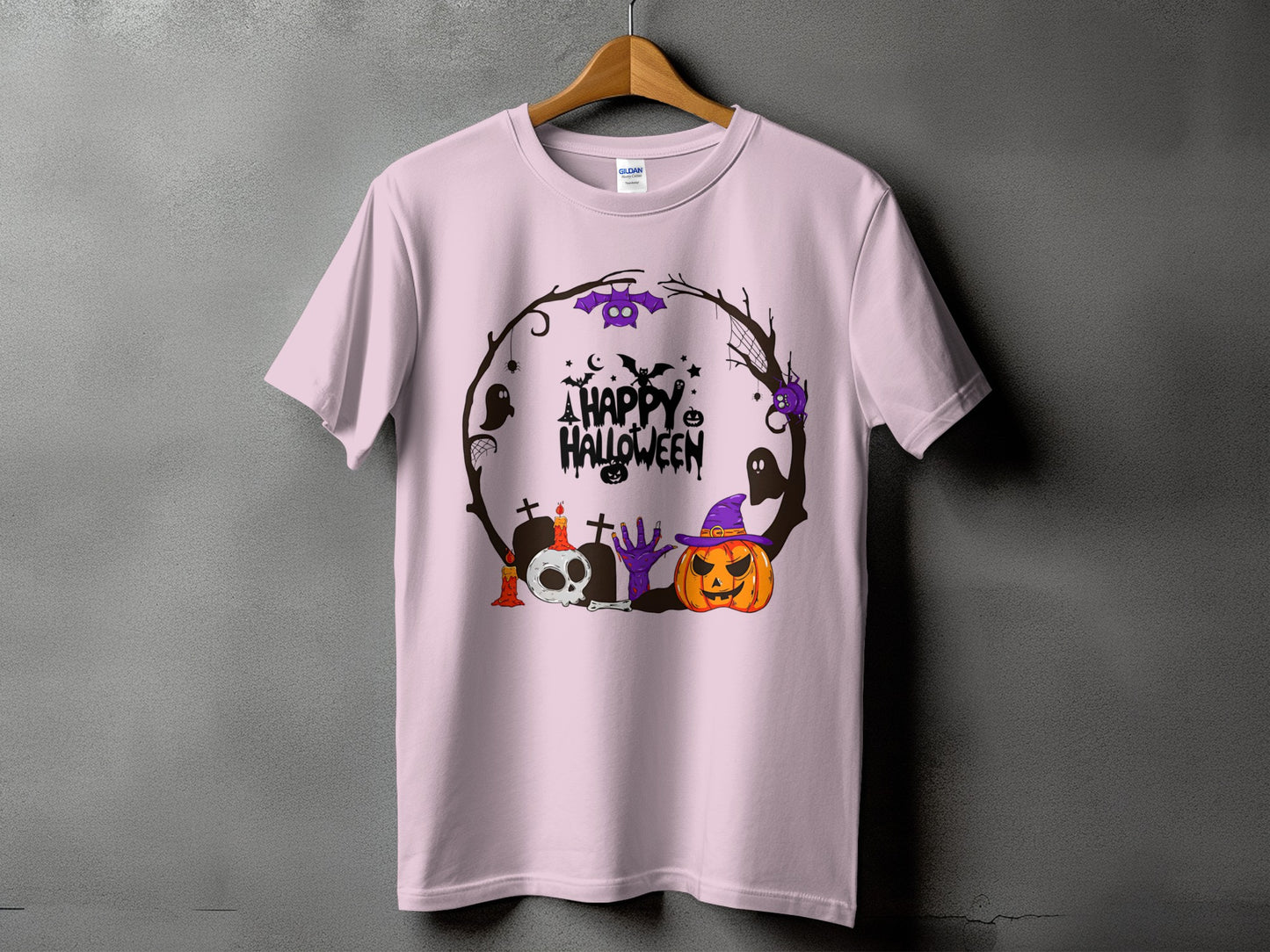 Pink t-shirt with a Halloween wreath graphic featuring a skull, pumpkin, and ghosts.