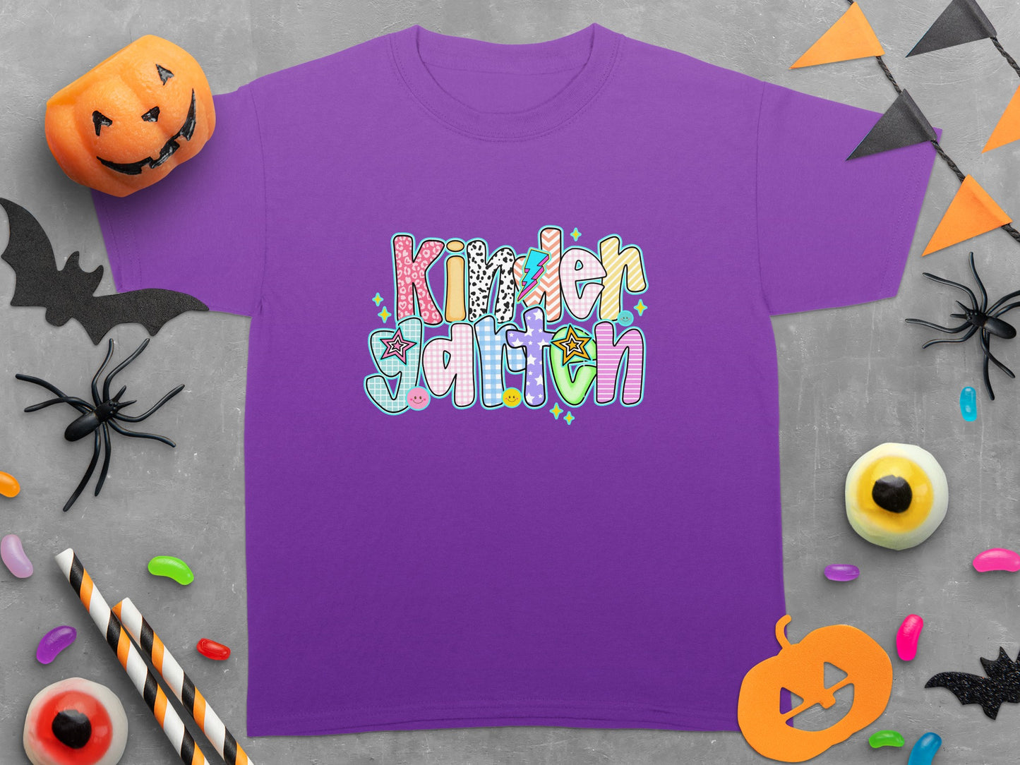 Purple kids t-shirt with "Kindergarten" in colorful, patterned block letters.