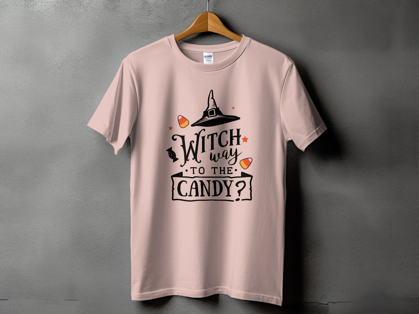 Pink t-shirt with black Halloween graphic text "Witch way to the candy?".