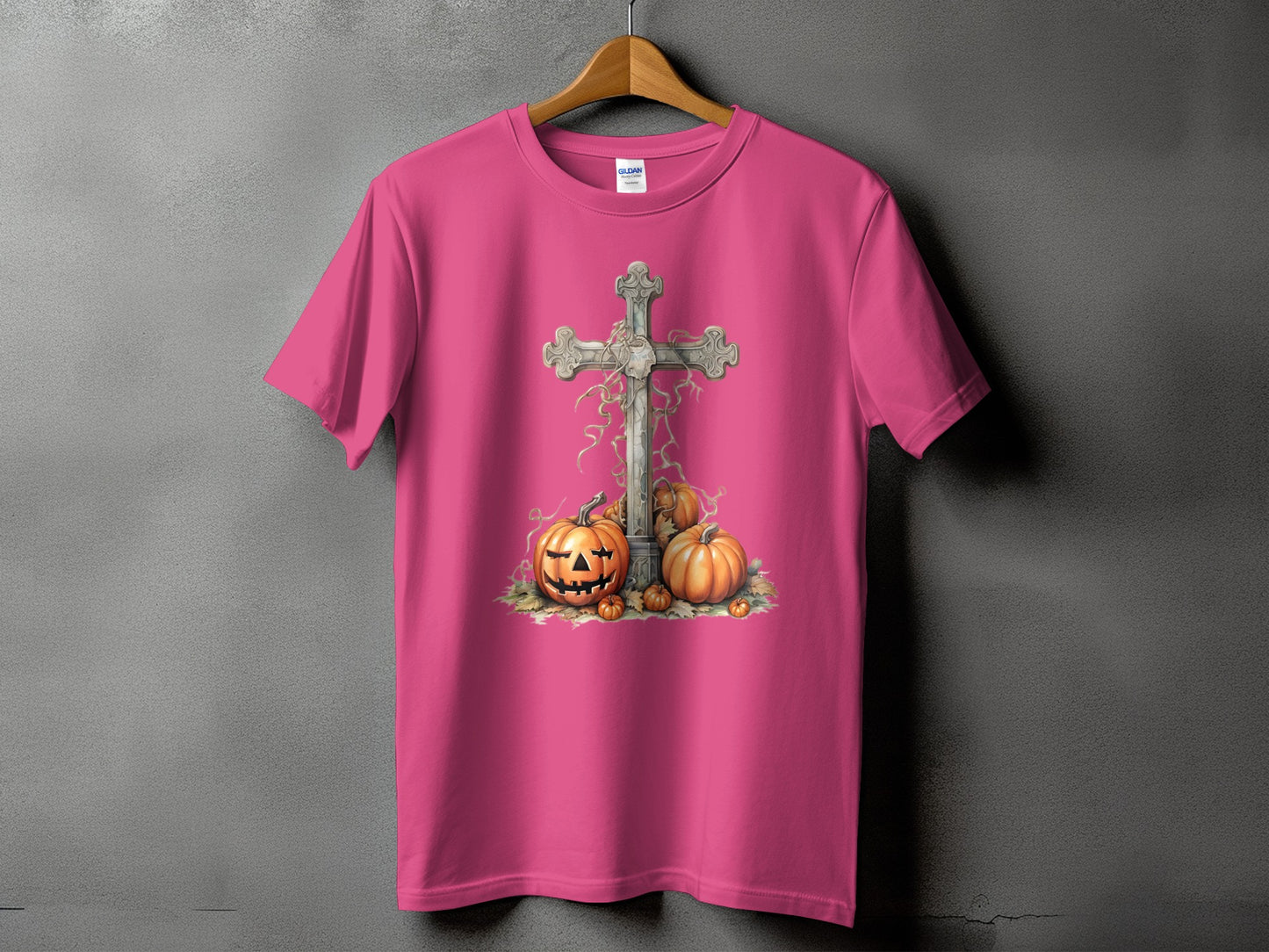 Pink t-shirt with graphic of cross and pumpkins.