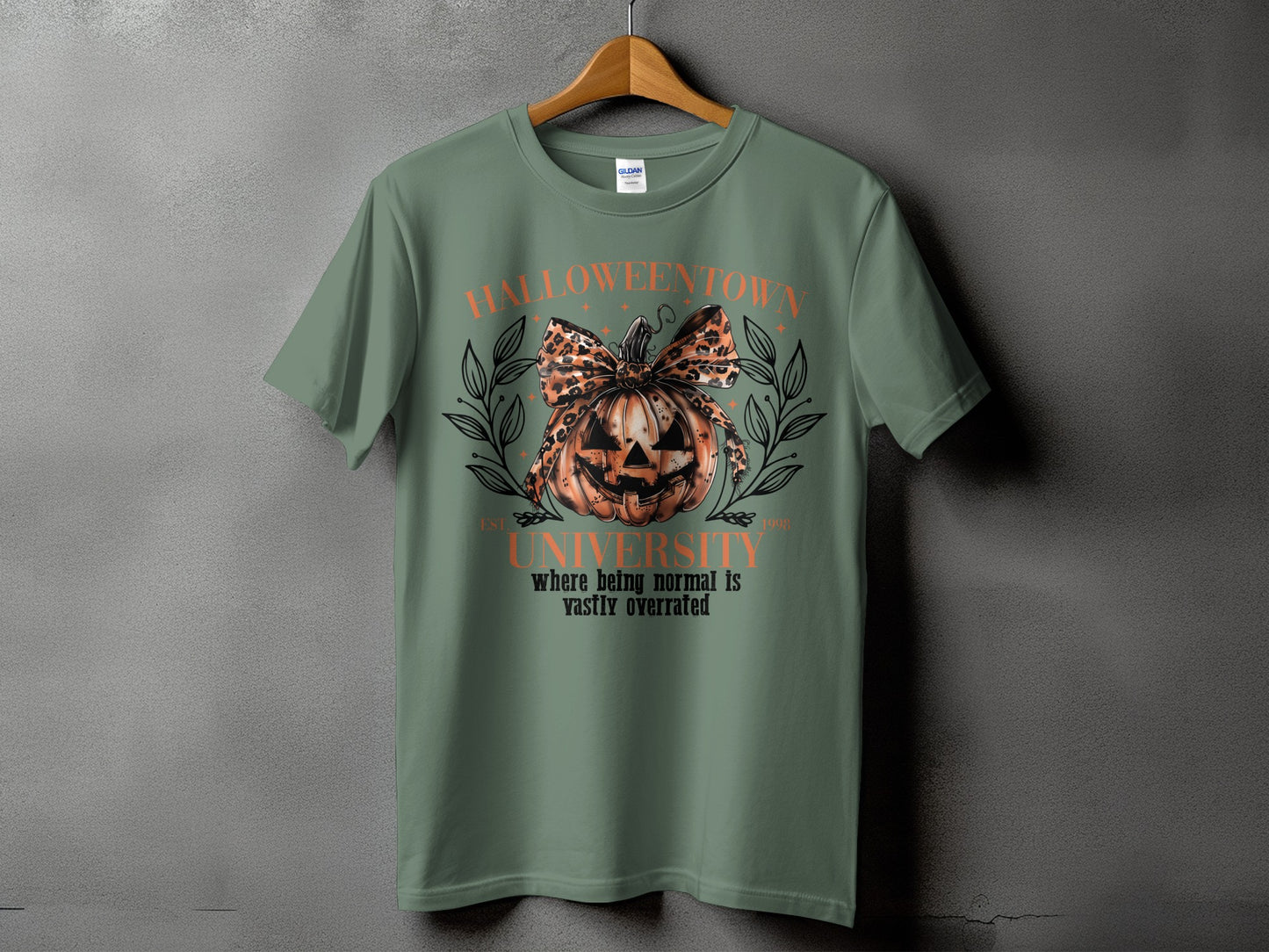 Green t-shirt with "Halloween University" and a leopard print bow on a jack-o'-lantern.
