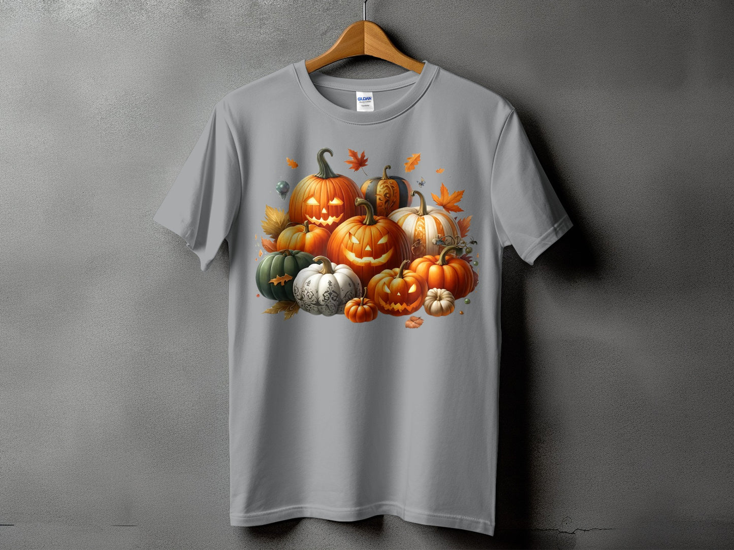 Gray t-shirt featuring a collection of carved and decorative pumpkins with autumn leaves.