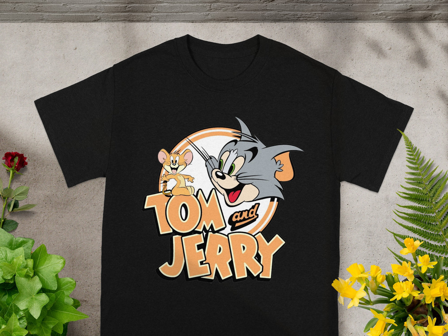 Black t-shirt with Tom and Jerry characters and text.