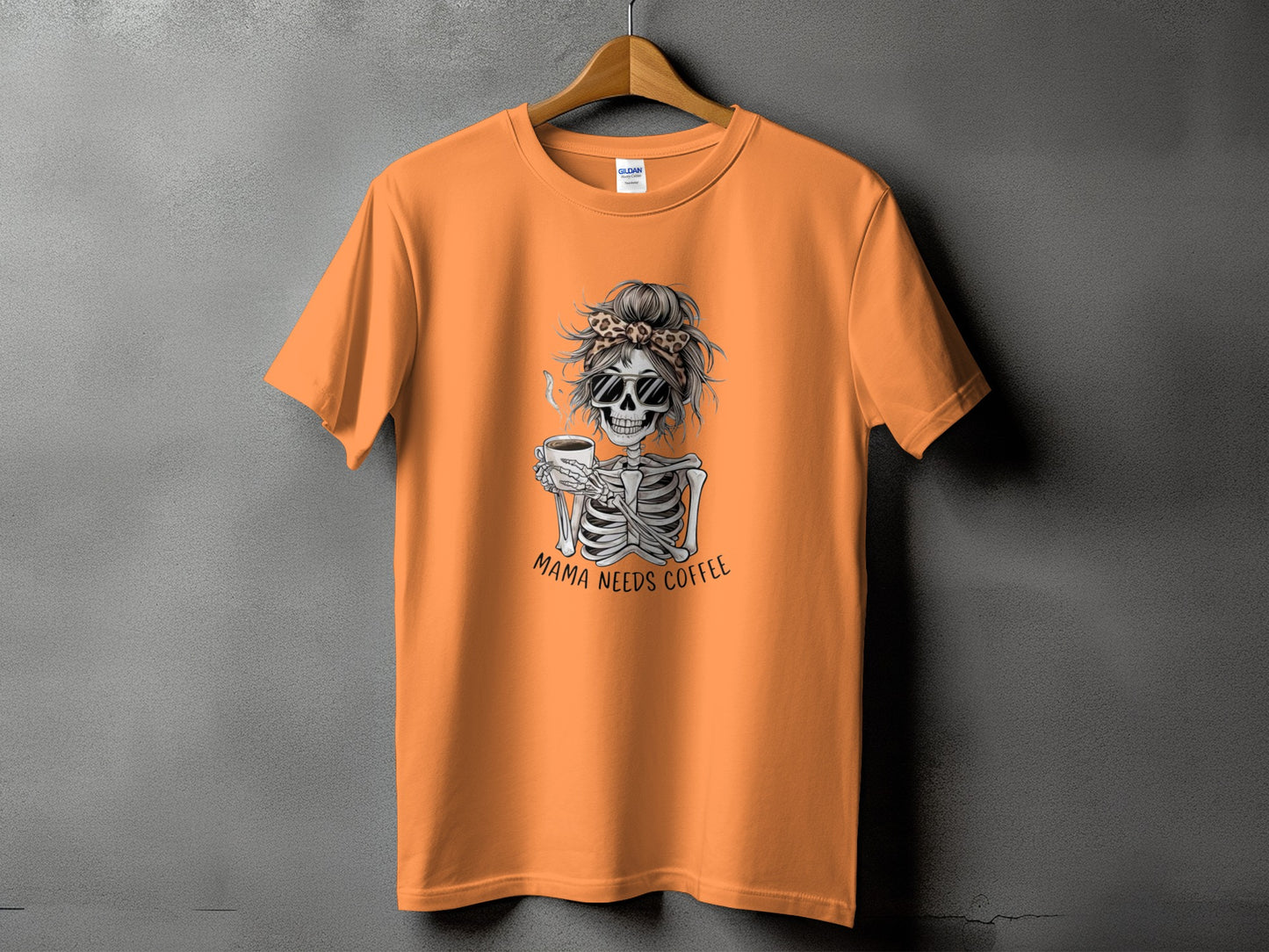 Orange t-shirt with skeleton graphic and text "Mama Needs Coffee".