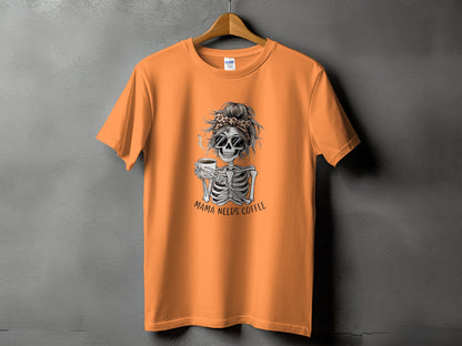 Orange t-shirt with skeleton graphic and text "Mama Needs Coffee".