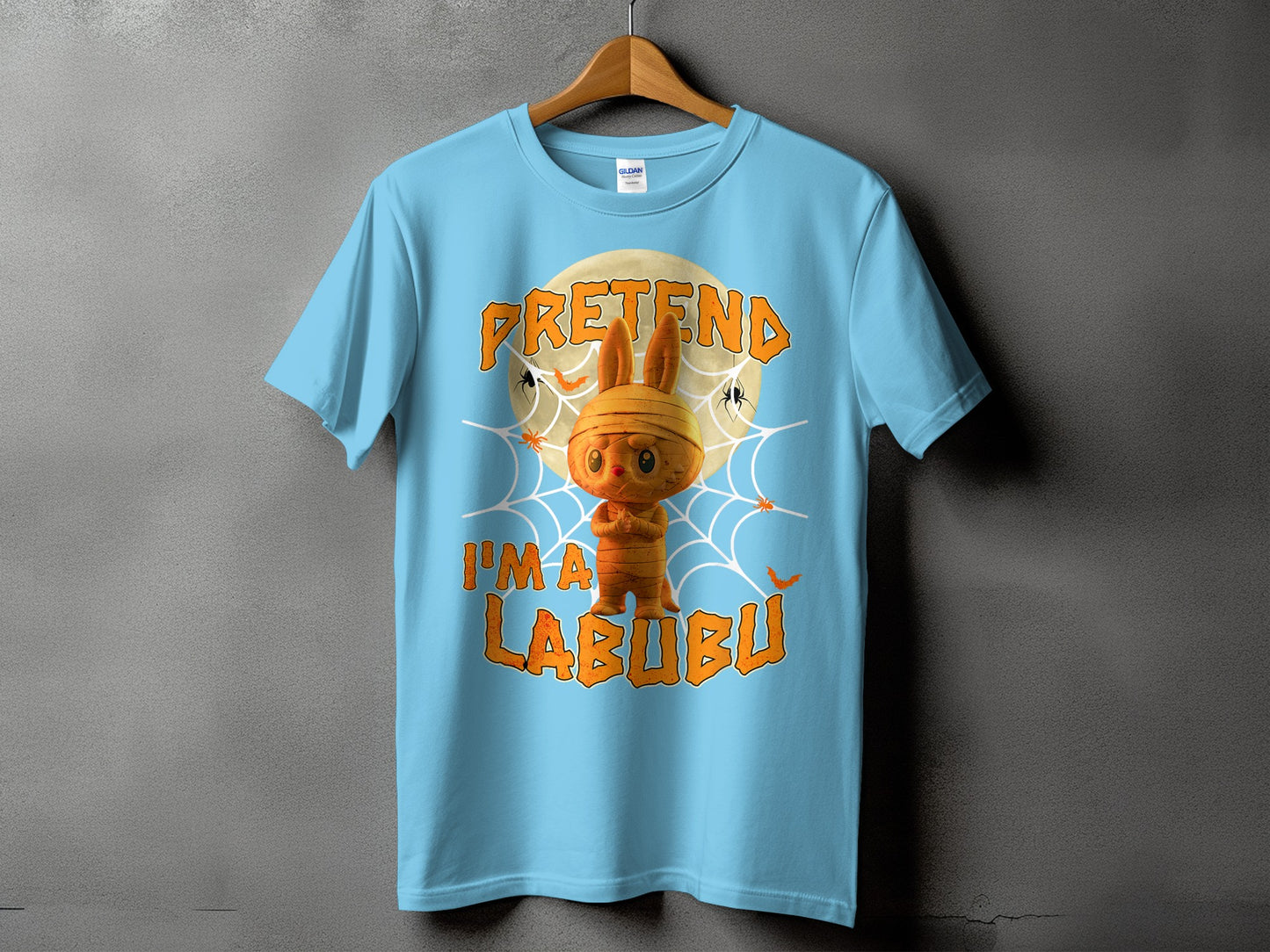 Light blue t-shirt with a mummy Labubu graphic and "PRETEND I'M A LABUBU" text.