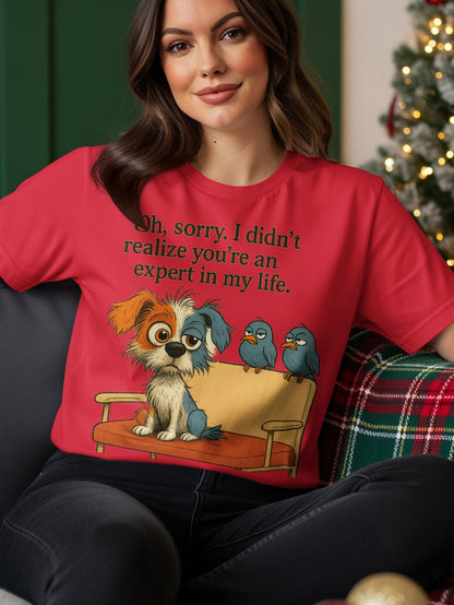 Red t-shirt with a cartoon dog and birds on a couch, text says "Oh, sorry. I didn't realize you're an expert in my life."