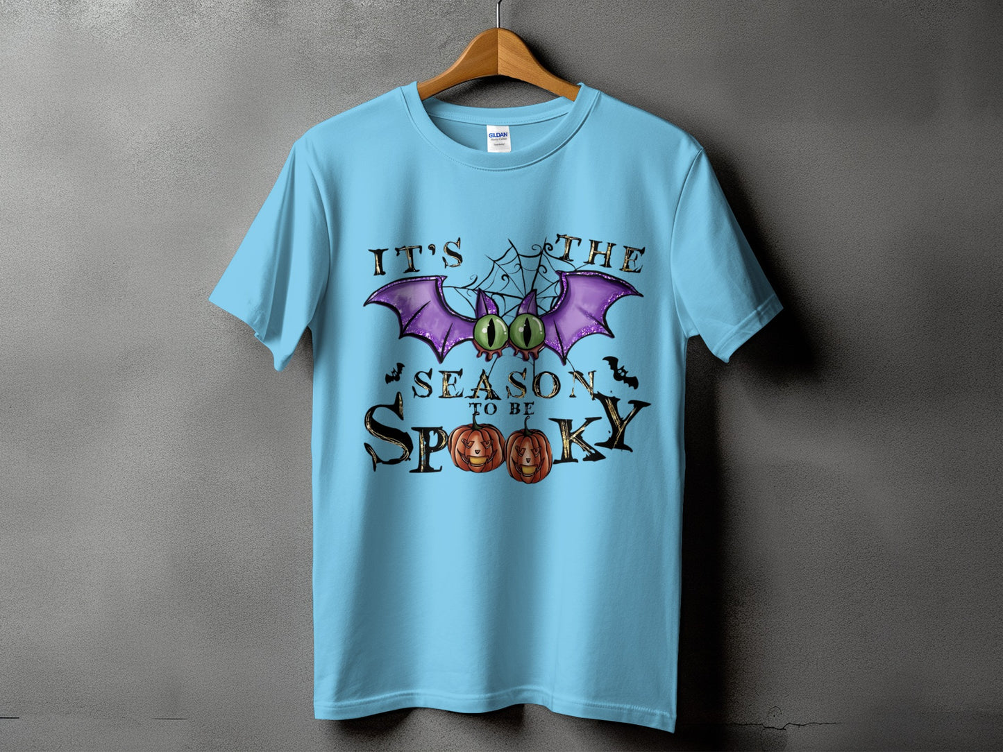 Light blue t-shirt with "It's The Season To Be Spooky" Halloween graphic.