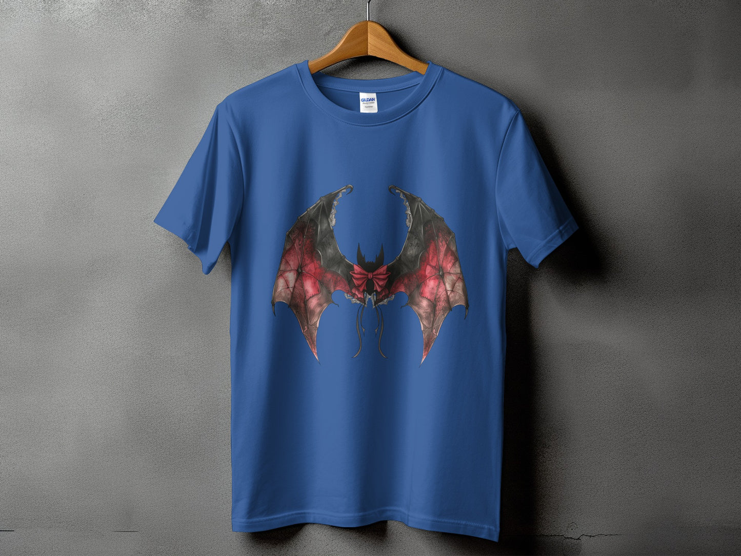 Blue t-shirt with dark red and black bat wings design and red bow.