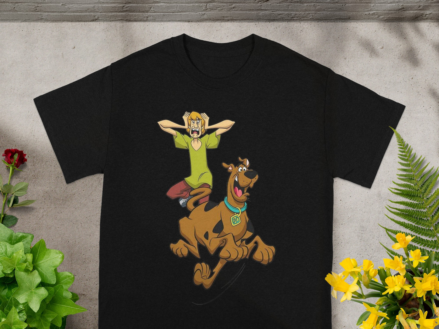 Shaggy and Scooby-Doo jumping in fright on a black t-shirt.