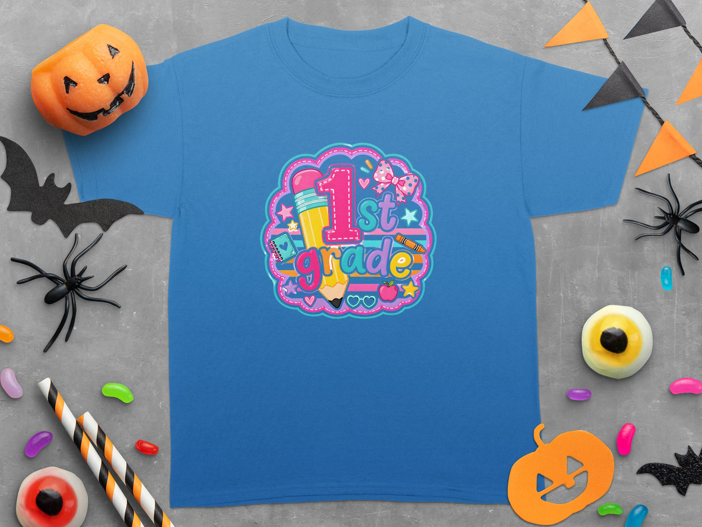 Blue t-shirt with "1st Grade" graphic featuring a pencil, apple, and bow.