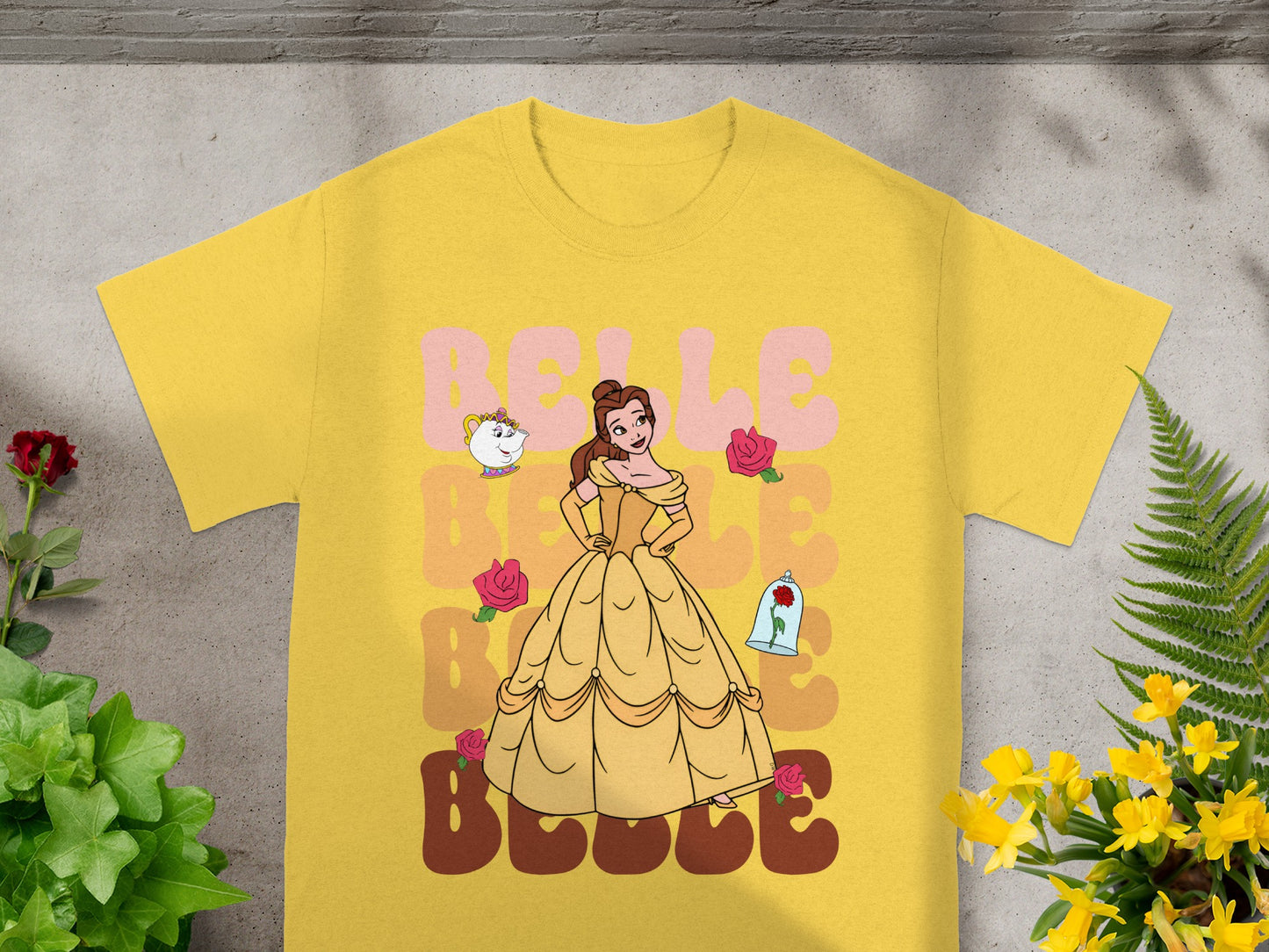 Belle with roses and a teacup on a yellow t-shirt.