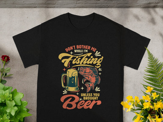Black t-shirt with fishing and beer graphic reading "Don't bother me while I'm fishing, unless you brought beer."