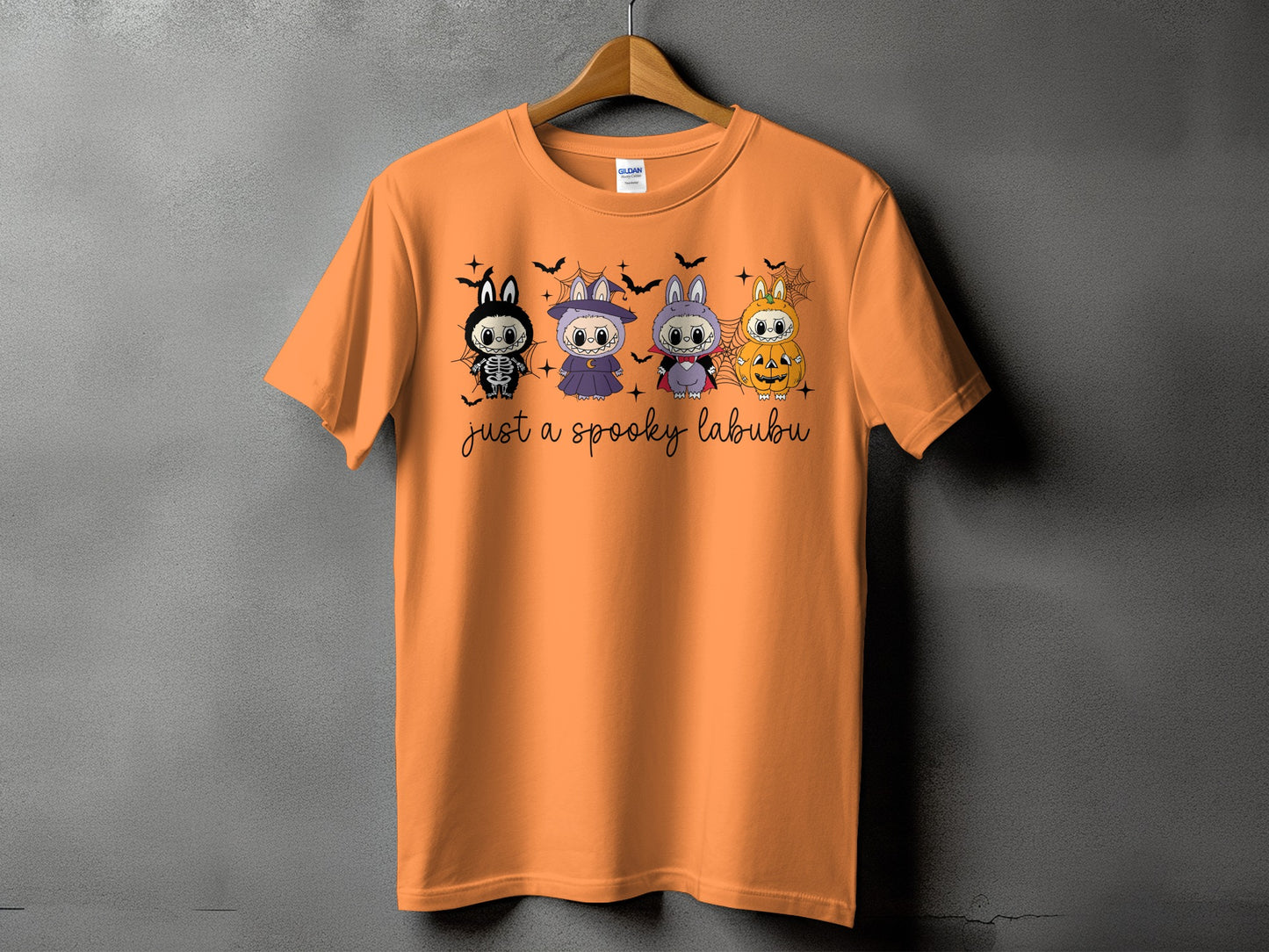 Orange t-shirt with "just a spooky labubu" text and Halloween-themed characters.
