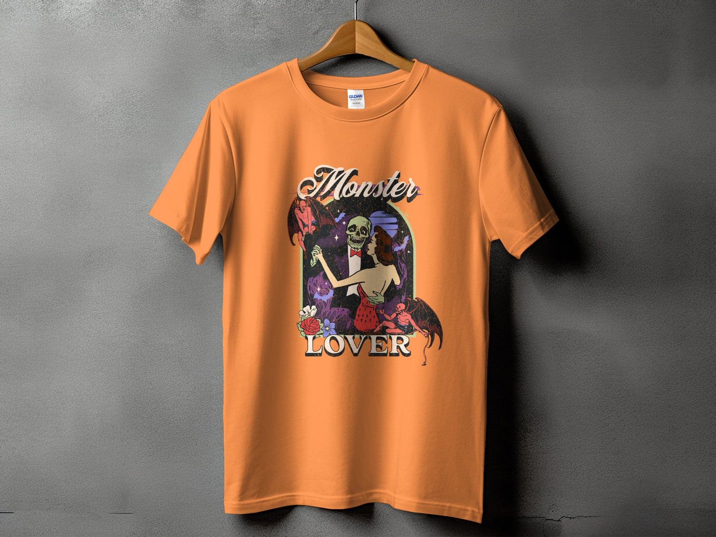Orange t-shirt with a "Monster Lover" graphic of a skeleton and woman dancing with demons.