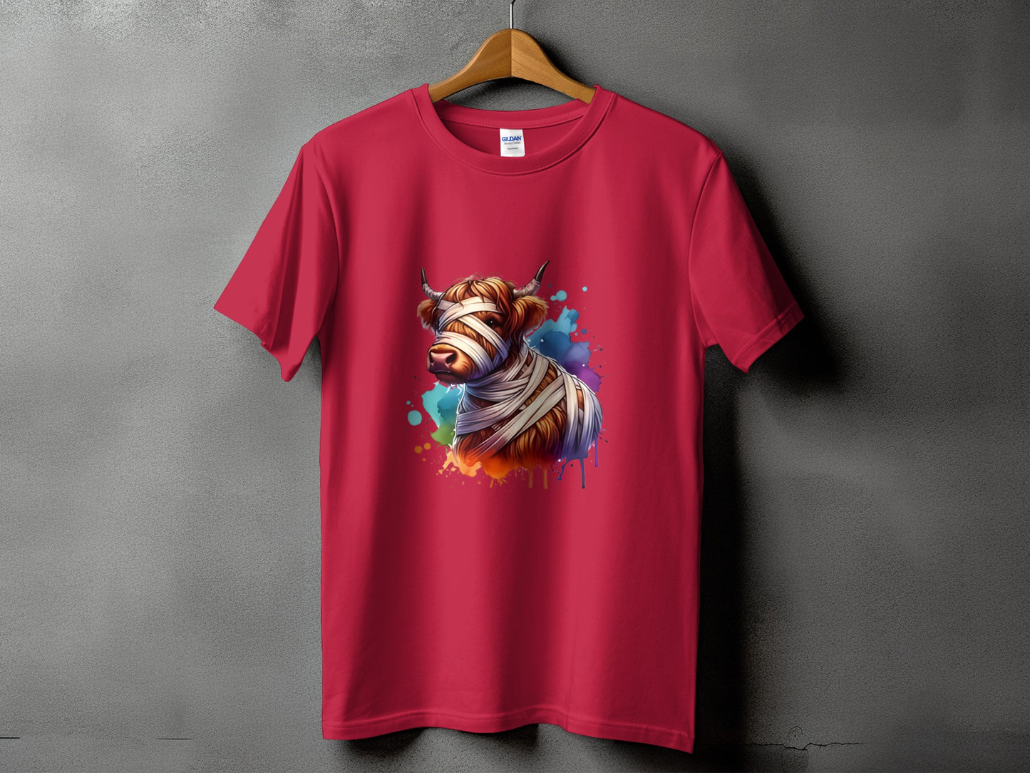 Red t-shirt with a watercolor highland cow wrapped in bandages graphic.