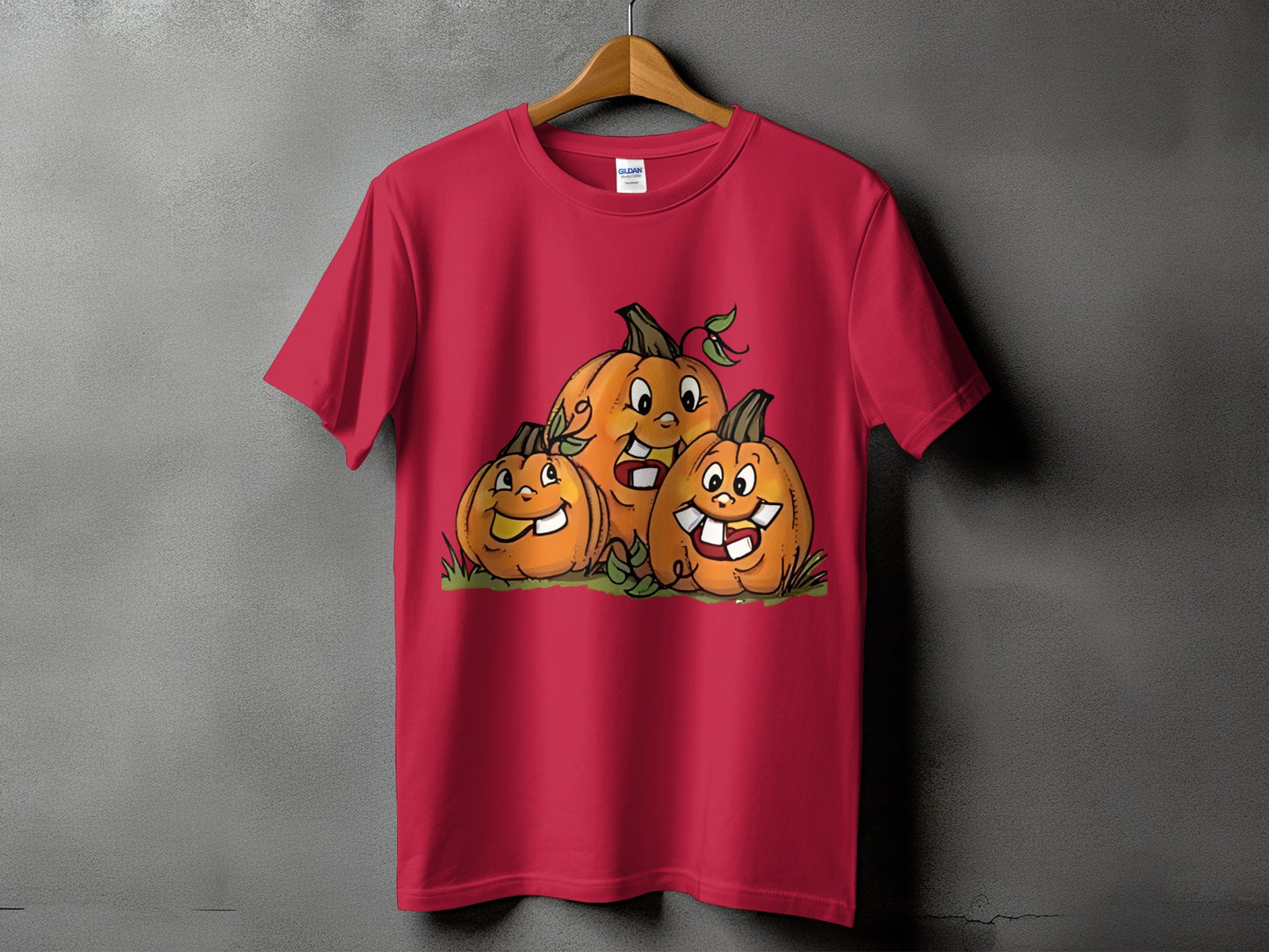 Red t-shirt with a graphic of three smiling pumpkins with cartoon faces.