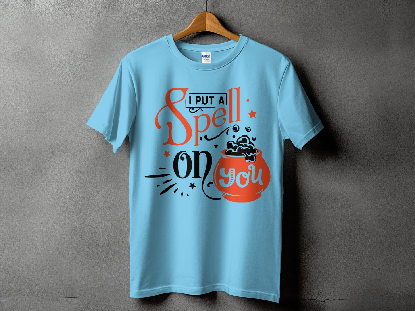 Light blue t-shirt with "I Put a Spell on You" and cauldron graphic.