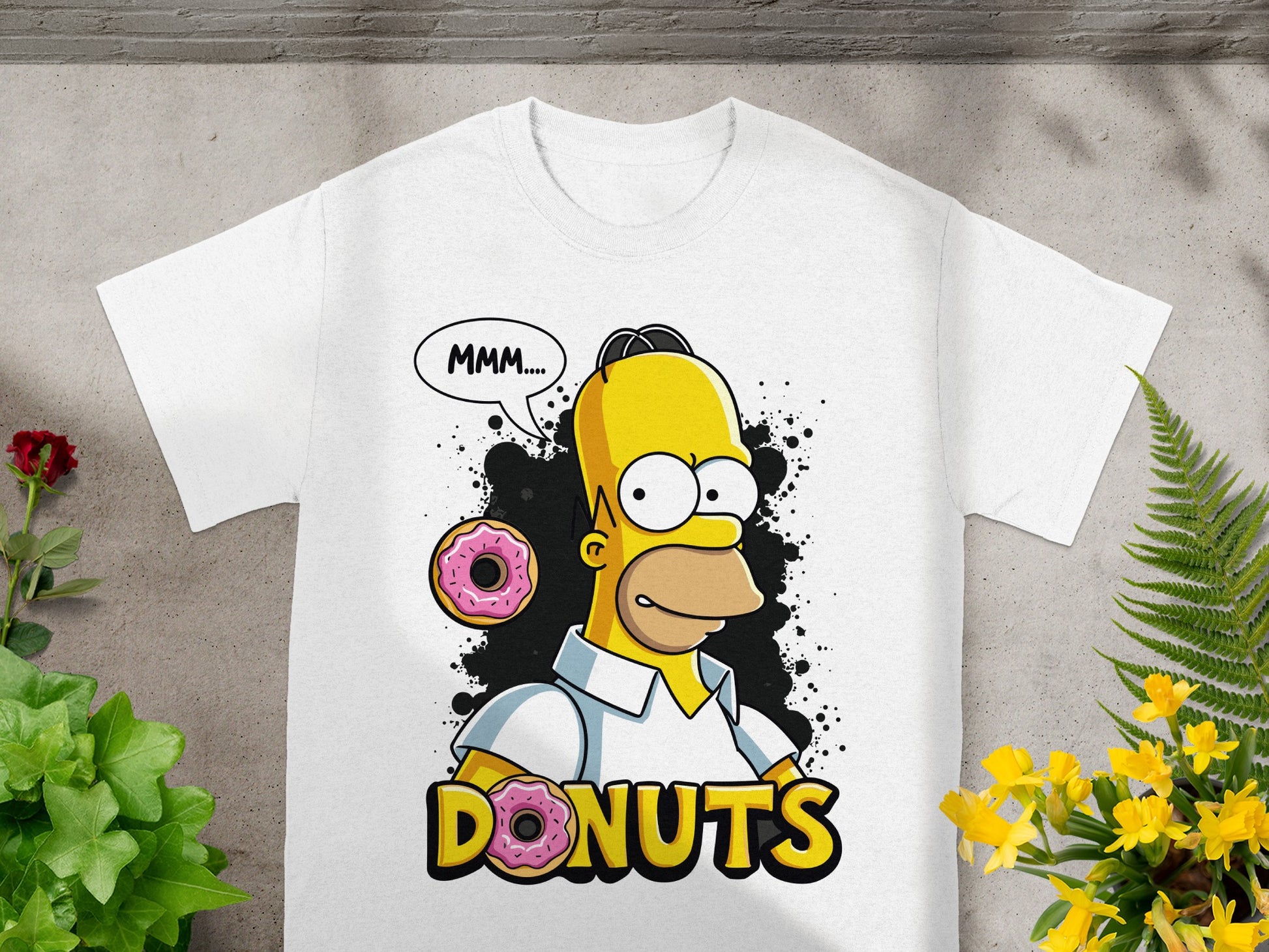 White t-shirt with Homer Simpson saying "MMM..." next to a donut.