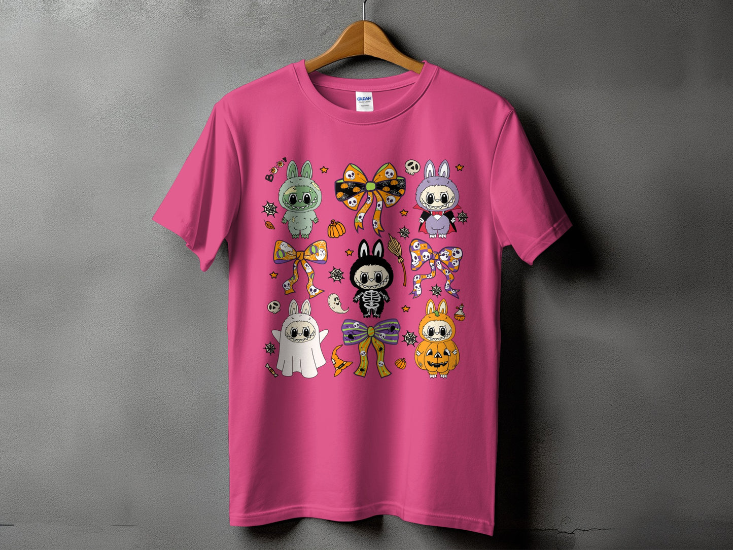 Pink t-shirt with various cute Halloween characters and festive bows.